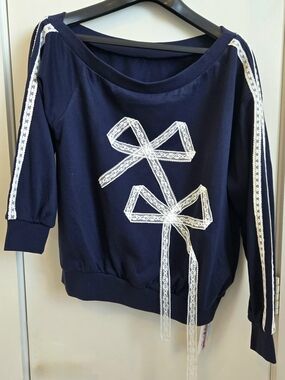 New Cider Navy Blue Off-Shoulder Sweatshirt with White Lace Bow Accents